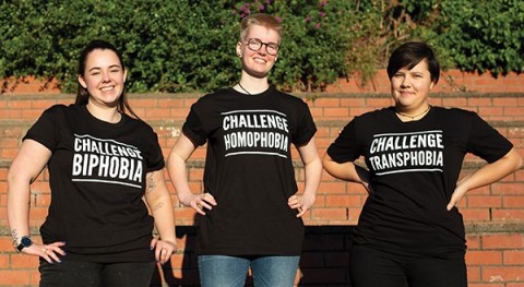 Three people wearing Challenge Biphobia and Challenge Transphobia t-shirts